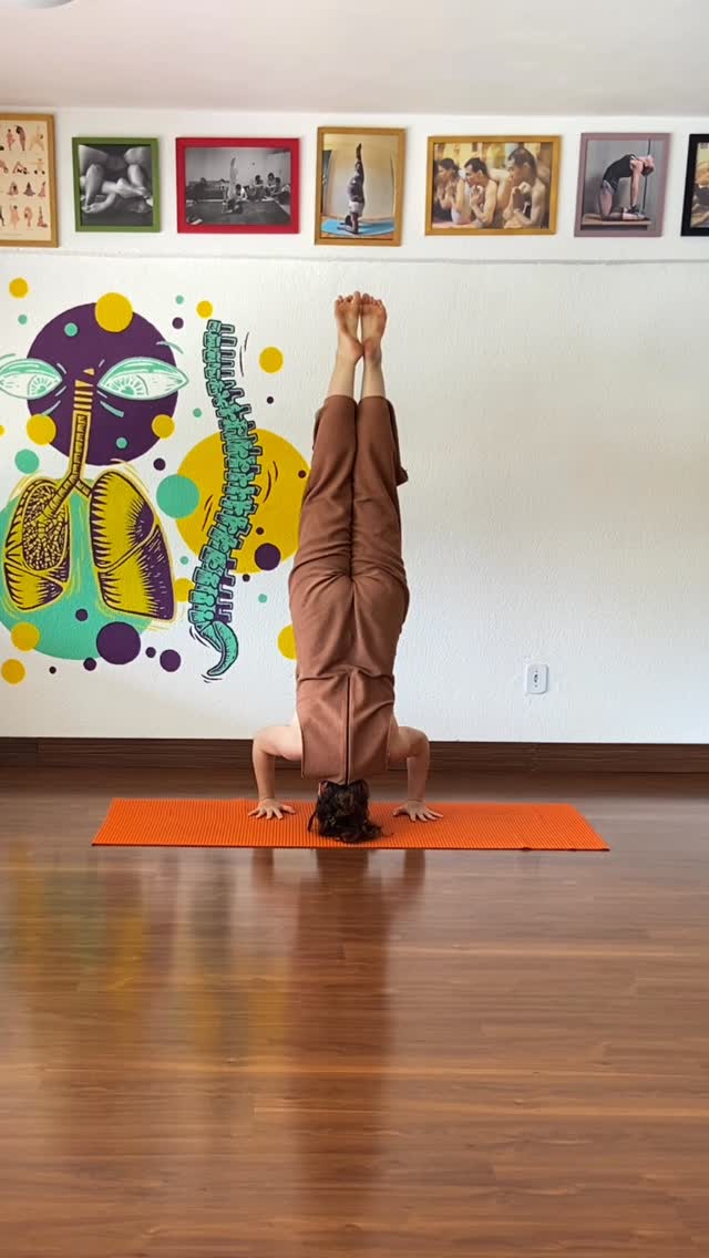Prática de yoga em estúdio com mural colorido